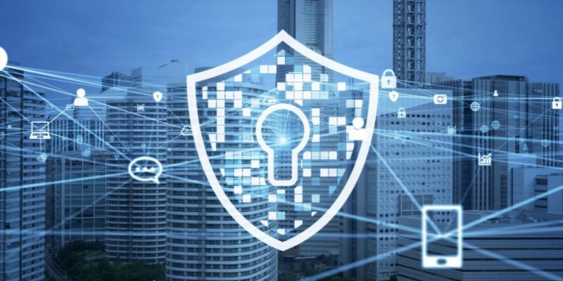 A digital padlock shield icon overlays a cityscape, symbolizing cybersecurity and network protection with connected lines between technology devices.